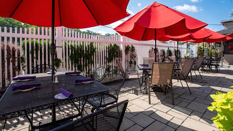 Patio seating with set tables and umbreallas