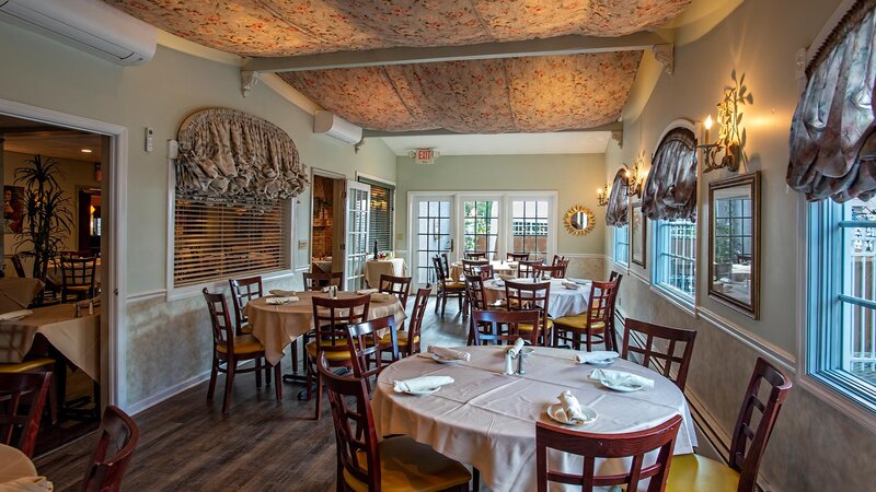 Rear dining area with four set tables