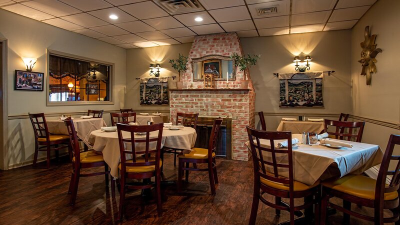 Dining room with fireplace and five set tables